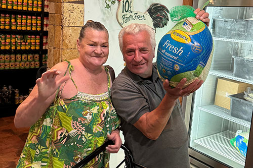 SoH—Turkeys-&-Clients a couple holding a turkey package
