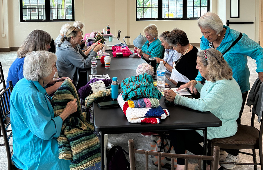 senior volunteers knitting